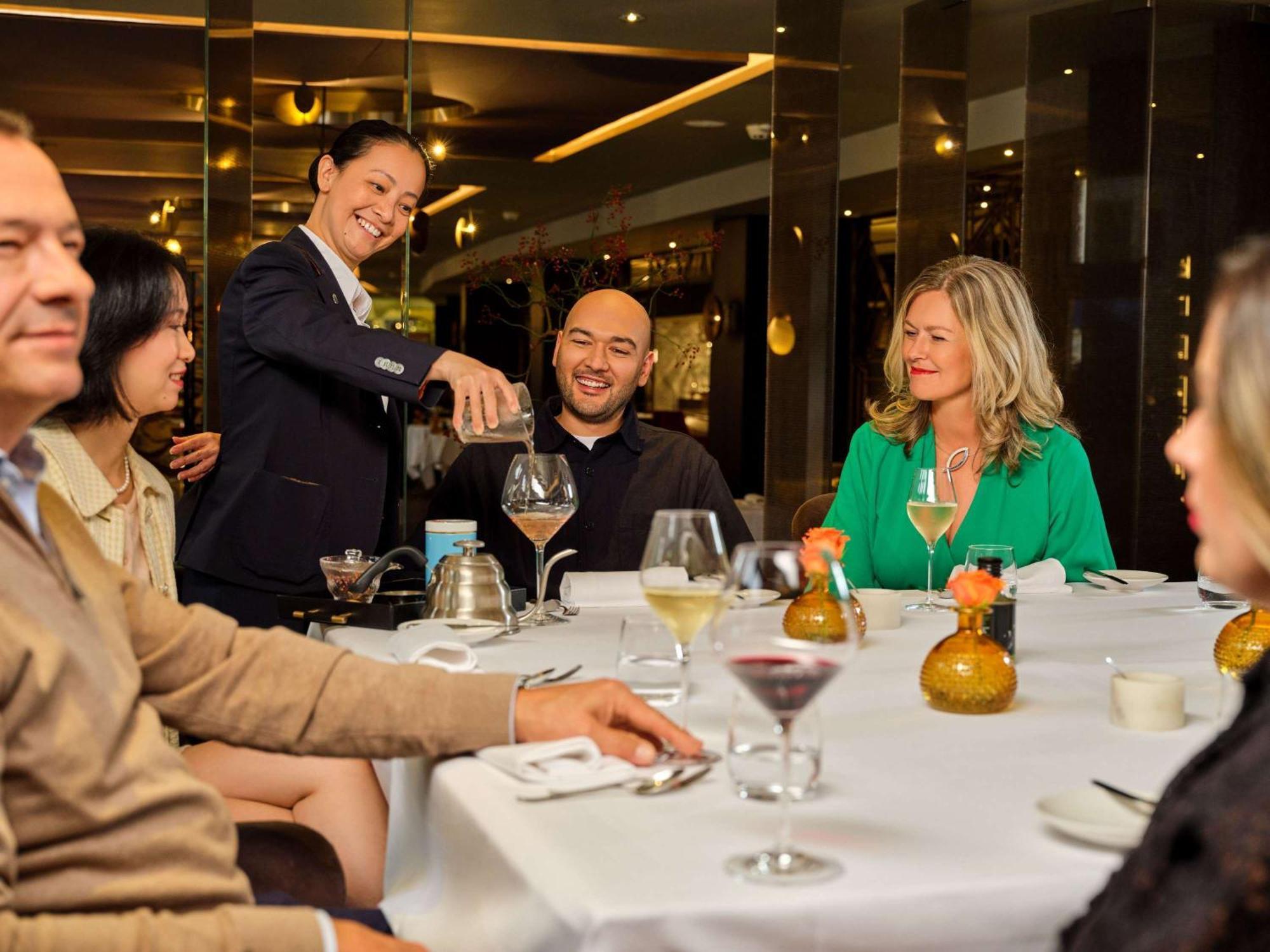 Hotel Sofitel Legend The Grand Amsterdam Esterno foto A wine steward serves wine at a restaurant